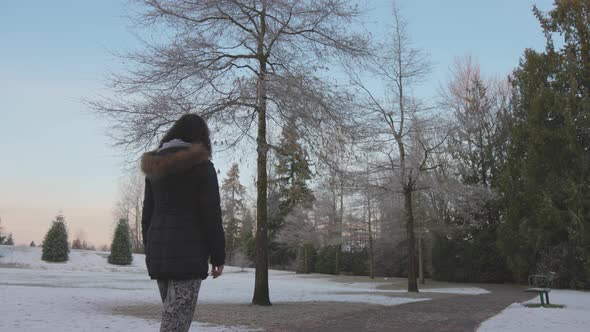 Girl Walking in a Park During Foggy Winter Sunrise