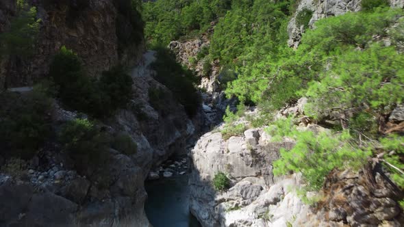 Aerial View of Gorge in Mountains Where River is Flowing and Tourist Path for Walking