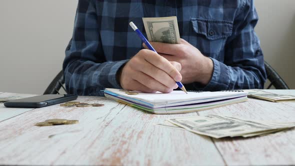 Man counting money, calculating family budget, accounting bills.