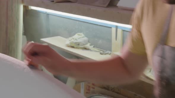 Male surfboard maker in his workshop