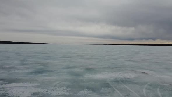 Low Over Frozen Lake Cloudy Sky Backwards