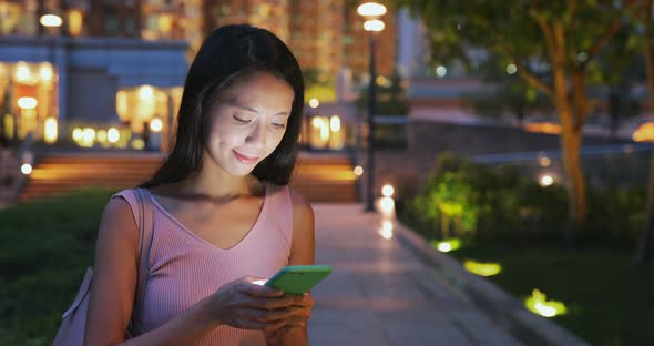Woman use of mobile phone at night 