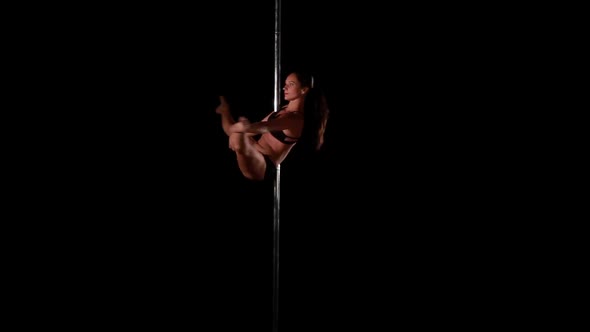 Sexy Female Pole Dancing on Black Background