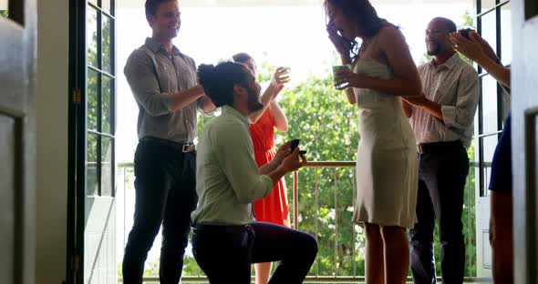 Man proposing woman with ring by kneeling down