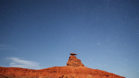 Time lapse of the night sky behind the rock formation of Mexican Hat