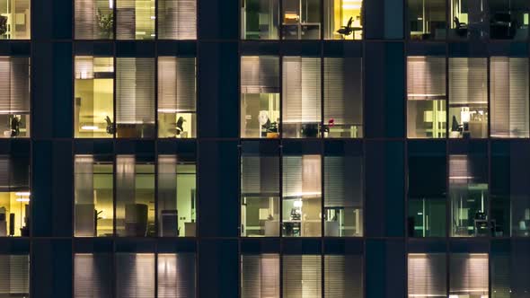 Window of the Multistorey Building of Glass and Steel Lighting and People Within Timelapse