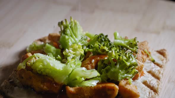 Sprinkling Sesame Seeds On Anabolic Toast Sandwich With Chicken Breast And Steamed Broccoli, Dressed