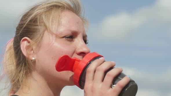 Female Drinking a Bottle of Water After Sport