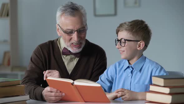 Grandpa Reading Aloud Adventure Story to Little Grandson, Family Care and Warmth