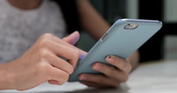 Woman Using Mobile Phone in Coffee Shop 