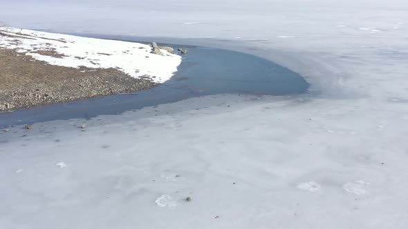 Surface of frozen lake by morning 4K aerial video