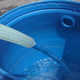 Garden Water Hose Trickling Into Tank