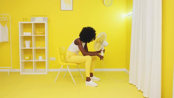 Tired Woman Is Relaxing In Yellow Office