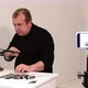 Man Shows a Master Class on Sharpening a Knife on a Machine - VideoHive Item for Sale