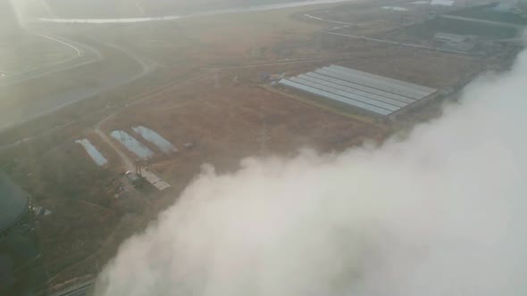 Aerial Orbital View of an Industrial Zone Pipes Pouring Thick White Smoke