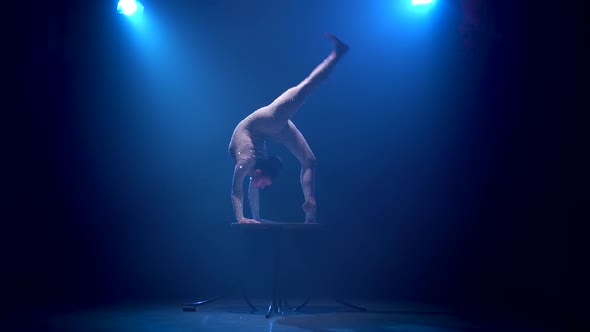 Acrobat Girl on Stage Does Acrobatic Stunts Standing on Her Hands