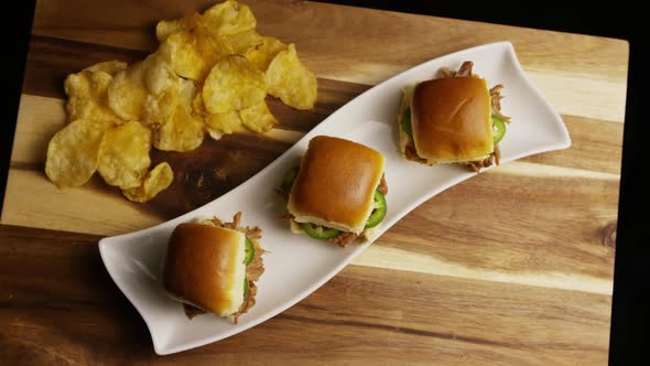 Rotating shot of delicious pulled pork sliders