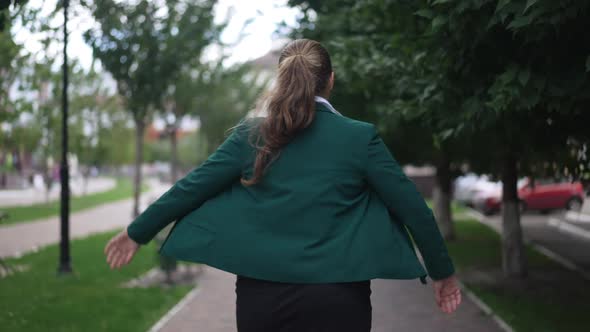Back View Obese Woman Walking Away in Slow Motion Along City Sidewalk