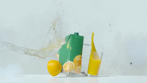 Explosion of an orange juice pack and a glass of juice, Ultra Slow Motion