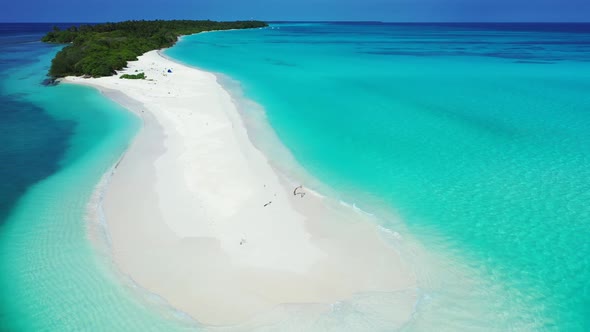 Luxury above abstract shot of a paradise sunny white sand beach and aqua blue water background in 4K