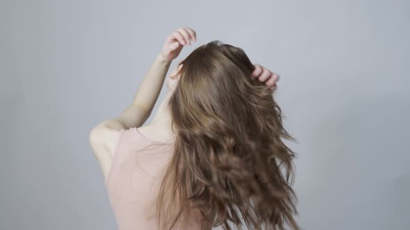 A Young Woman Shaking Her Healthy Hair