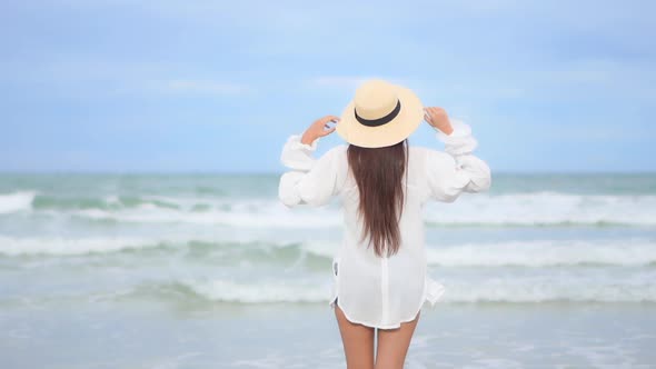 Asian woman enjoy around beautiful beach sea ocean