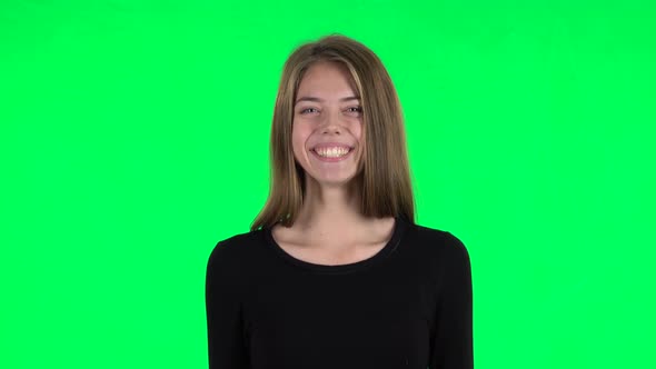 Young Woman Smiling While Looking at Camera and Laughing. Green Screen