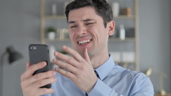 Sad Young Man Reacting to Online Failure on Smartphone