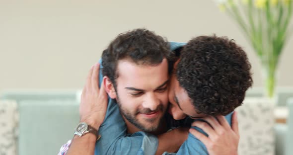 Gay Couple Embracing in the Couch