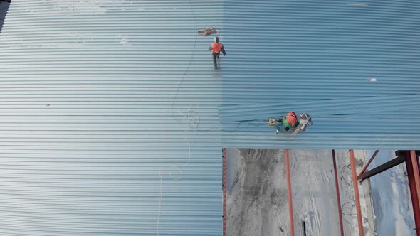 Aerial Shot. Shooting From the Air. In the Frame of the Workers Are Builders, Mount the Roof of the