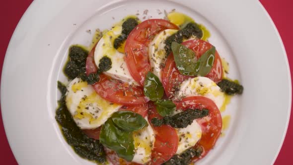 Vertical video: Mozzarella with tomato in a plate