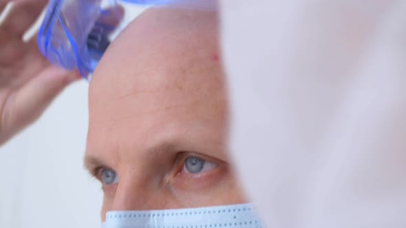 Closeup of the Face of a Doctor Who Takes Off His Glasses After a Successful Surgical Operation