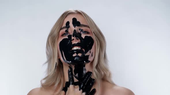 Charming Blonde Girl Applies Cosmetic Mask Environmental Pollution. Black Oil.