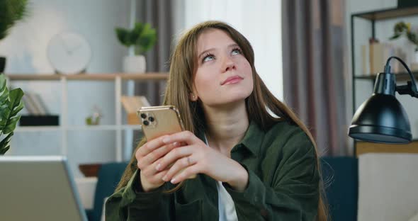 Girl in Casual Clothes Sitting at Her Workplace at Home when Thinking About answer