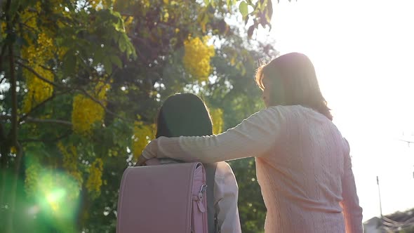 Asian Mother Talking Her Daughter With Backpack Outdoors, Back To School 4