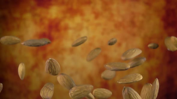 Close Up of Delicious Almonds Bouncing on a Yellow Ochre Background