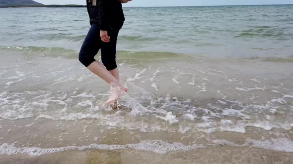 Woman Walking on Irish Beach in County Donegal