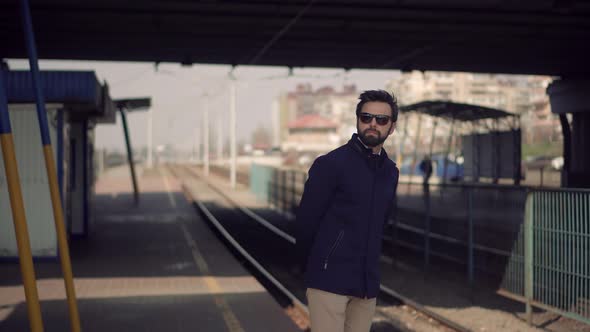 Businessman Commute To Work Sitting On Railway Train Station Platform. City Tourist Transportation.
