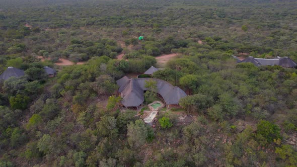 Luxurious African rural lodge with pool  in middle of bush in green savannah. Aerial view