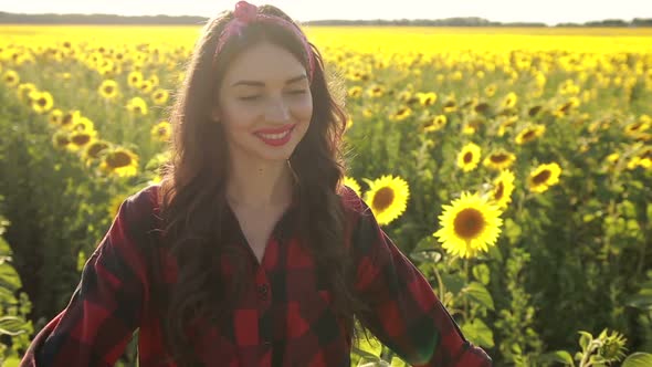 Happy Woman Walking in Fresh Sunflower Field