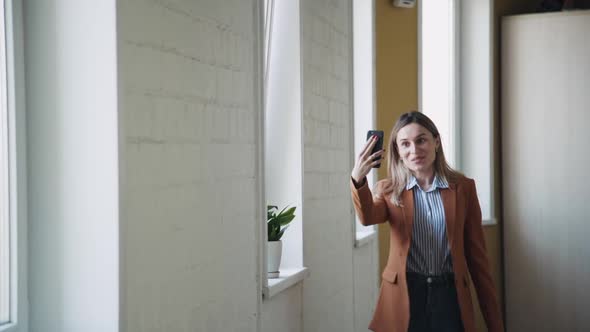 Woman Holding Smartphone in Hands and Making Video Call