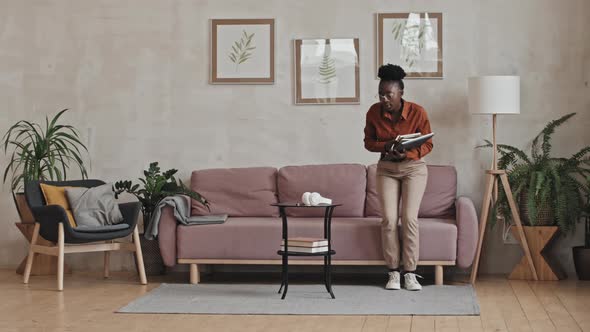 Black Woman Sitting on Sofa and Studying Online via Video Call