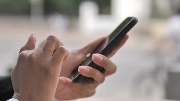 African Female Hand Using Smartphone