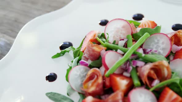 Salad with wine served on plate