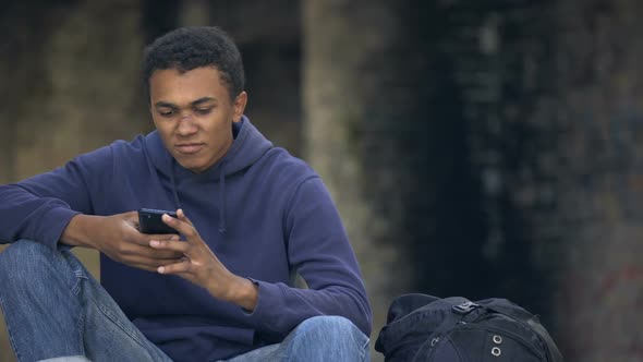 African Teenager Looking Angry Reading Smartphone Message, Family Problem Crisis