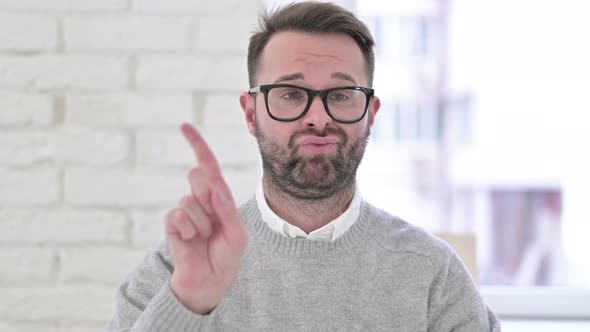 Portrait of Unhappy Man Waving Finger To Reject