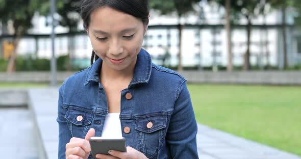 Woman use of mobile phone at outdoor 