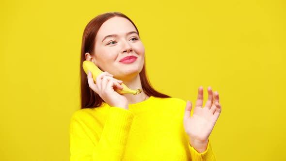 Redhead Positive Young Woman Using Banana As Phone