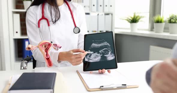 Doctor Gynecologist Showing Digital Tablet with Fetal Ultrasound to Pregnant Woman Movie Slow Motion