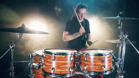 Musician with Dreadlocks Is Rehearsing Playing Drums